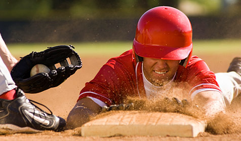 Baseball Business Analytics Baseball player sliding to home plate