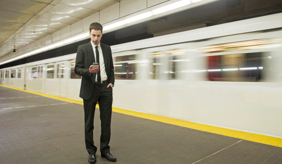 Enterprise Mobility Photo: Man Using Mobile Device beside High Speed Train